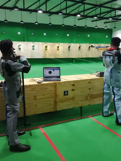 Our shooters using advanced training setups, including laptops for real-time shot analysis, at our new range location.