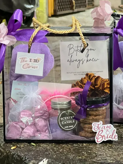 A close-up of a bridesmaid hamper, showing the layers of gifts inside. The "I Do Crew" tag is another fun detail I can add.
