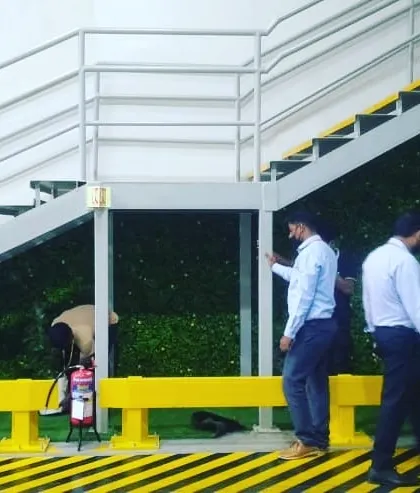 Here you can see my team during the installation process for the staircase green wall. We take great care to ensure every panel is perfectly fitted and the system is set up correctly for the plants to thrive.