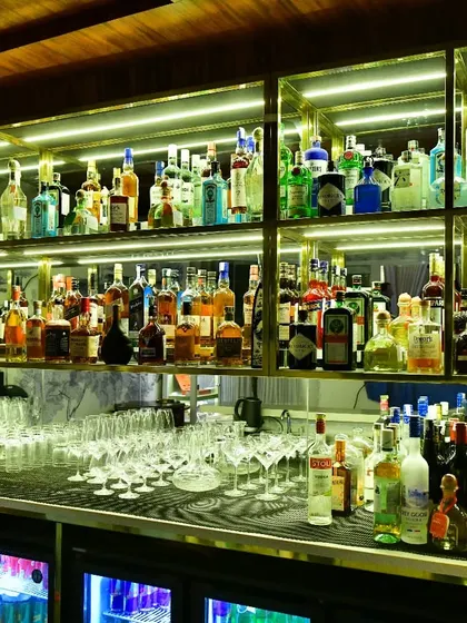 A look at our fully stocked bar, ready for the evening service. We offer a wide selection of premium spirits, wines, and liqueurs from around the world to complement your meal.