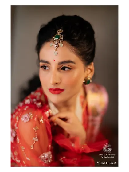 A detailed close up of Krishna's makeup. The sharp winged liner and bold red lip are hallmarks of a classic glam look, updated for the modern bride.