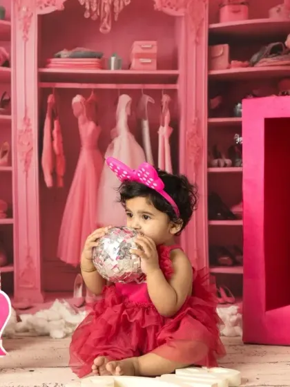 A little girl celebrating her first birthday, Barbie style. I provide the costume and props to make her milestone shoot extra special and vibrant.
