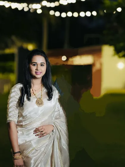 A night-time shot of Sowmya in her beautiful tissue silk saree, a vision of elegance.
