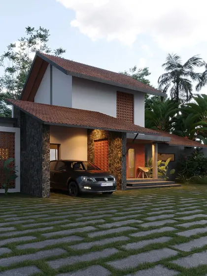A Mangalore project featuring natural stone cladding on the carport and entrance, paired with terracotta jali screens and a sloped roof.