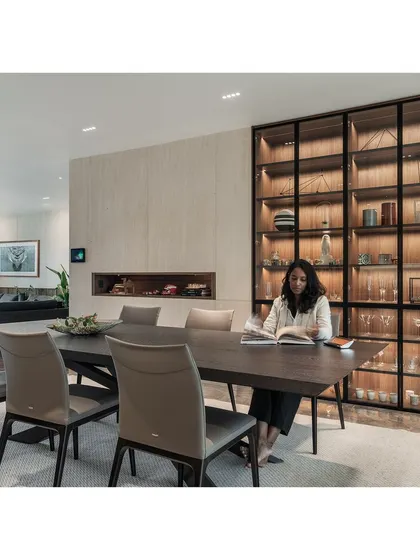 A quiet moment in the dining space. The design uses warm, ambient lighting and high-quality materials to create an inviting atmosphere for family meals and entertaining guests.