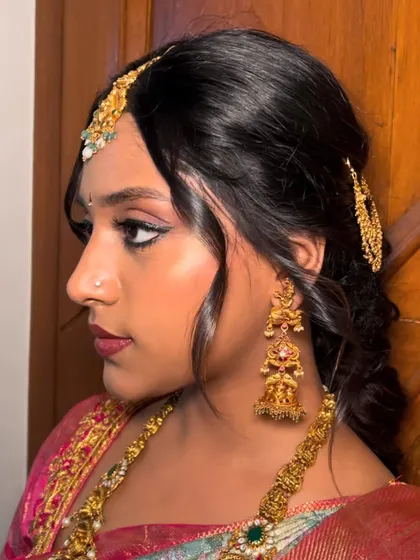 A side profile showcasing the intricate hairstyle and the flawless blend of the makeup. Every angle is considered to ensure a picture-perfect finish.