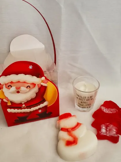 A cute little Christmas hamper featuring a snowman soap, a Santa soap, and a scented candle, all packed in an adorable Santa-themed gift bag.