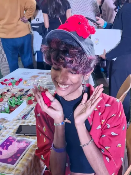 Having a super fun and candid moment at my stall. Running this small business is all about joy and community, and moments like this, with a crochet octopus on my hat, are what make it all worthwhile.