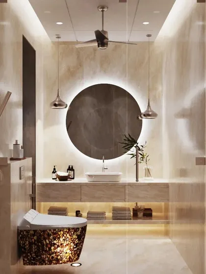 This bathroom design exudes warmth and tranquility. The space is clad in soft, beige-toned onyx, with a large, round backlit mirror creating a focal point above the floating vanity. The result is a serene, spa-like environment.