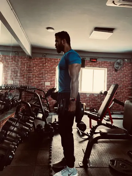 Nothing will work unless you do. Here I am in the middle of a dumbbell curl set, focusing on the bicep peak. I'll teach you how to isolate muscles for maximum growth.