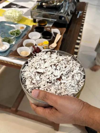 A bowl of freshly grated coconut, a key ingredient in many of our sattvic South Indian dishes. We use fresh, natural ingredients to create food that is both delicious and nourishing.