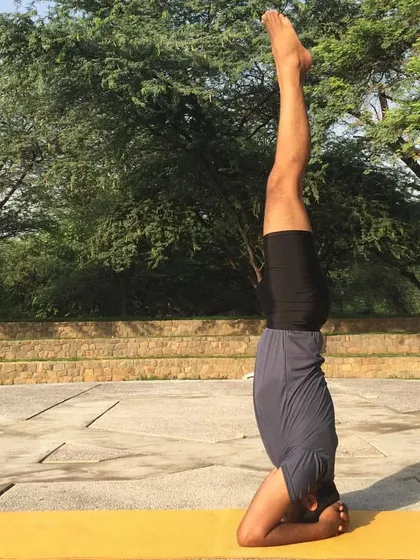 Once you feel stable in the egg shape, you can slowly extend the legs up to the ceiling to come into the full Sirsasana (Headstand). The key is to keep the shoulders active and the core engaged to maintain stability.
