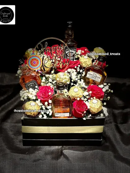 For a touch of class, I design premium liquor hampers like this one. It combines miniature alcohol bottles with Ferrero Rocher chocolates and fresh roses, creating a sophisticated and celebratory gift for any special occasion.