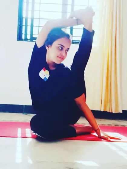 A seated pose demonstrating deep hip and shoulder flexibility. Sometimes it's better to wait for the body to be ready than to force things, and this is especially true in advanced stretching.