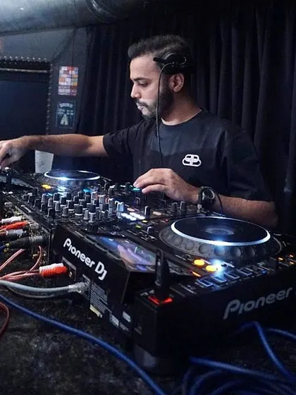 A classic DJ pose, focused on the mix with my Pioneer setup ready to go.