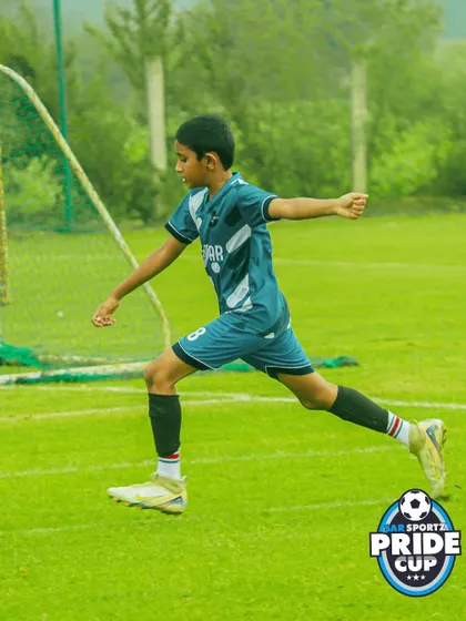 A young footballer mid-stride, showing the agility and speed that our league players develop over the season.