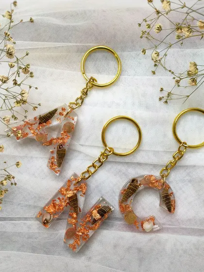 For the beach lovers, I create these initial keychains with real seashells and rose gold flakes. They are a perfect reminder of the ocean.