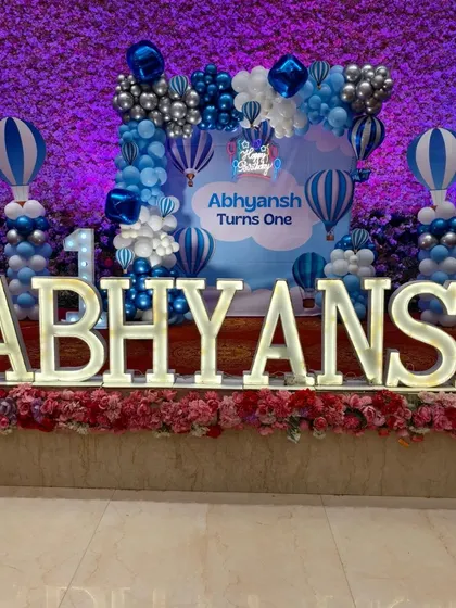 Large, illuminated marquee letters spelling out the birthday boy's name are a fantastic centerpiece for any stage setup. Here they are part of a Hot Air Balloon theme.