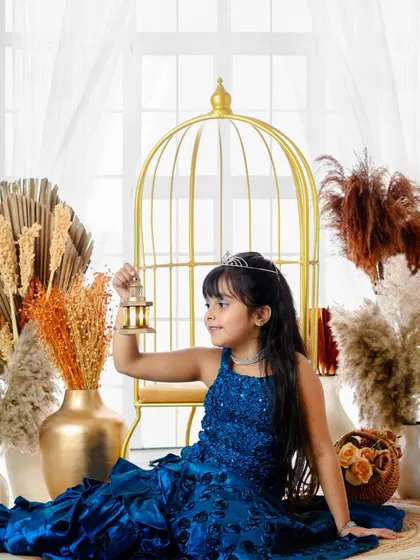 A princess and her golden cage. This imaginative shot adds a touch of royal elegance and wonder to her portrait session.