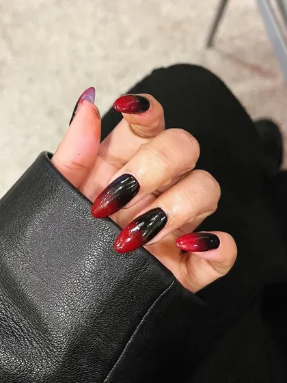 A dramatic red and black ombré on almond-shaped nails. This edgy, vampy look is perfect for making a bold statement.