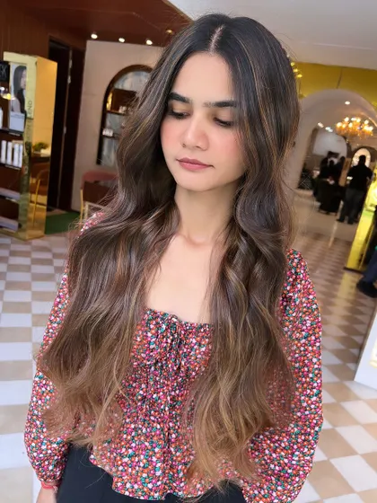 A gorgeous no-bleach balayage with a soft, seamless blend from dark roots to lighter ends. This is a great option for a gentle colour enhancement.