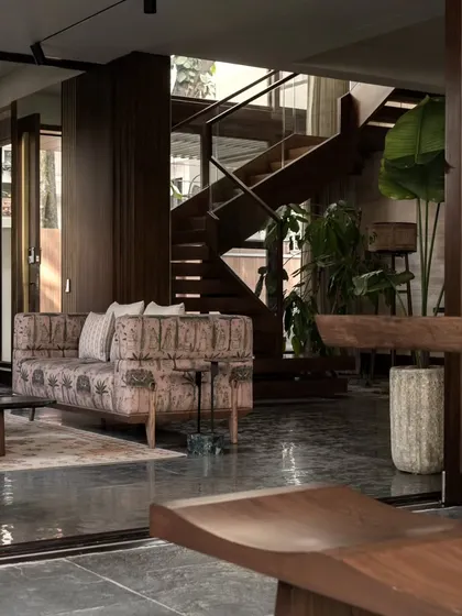 Looking back from the garden, this view shows the home's open-plan design. The living area, dining space, and staircase are all visually connected, creating a sense of spaciousness and unity.