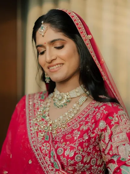 The bride with her dupatta, smiling happily. The makeup is designed to look great from every angle.