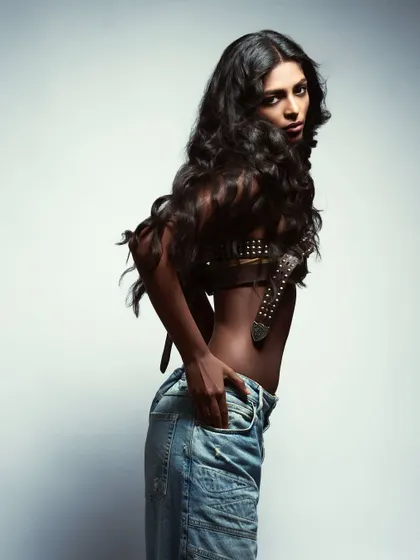 A powerful, high-contrast portrait of a model in denim.