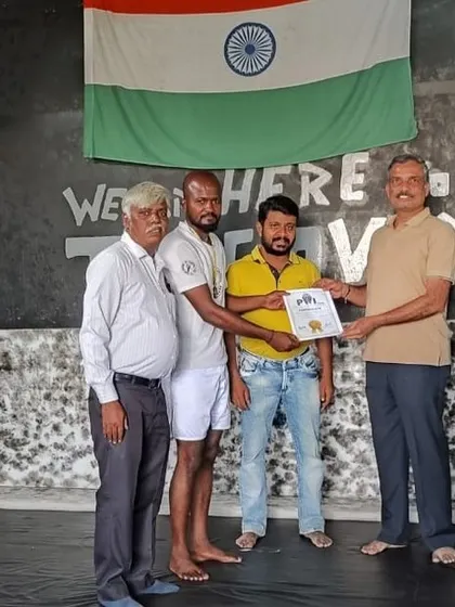 Our coach Rajith receiving his award at a ceremony. His achievements serve as a direct source of motivation for the students he trains every day.