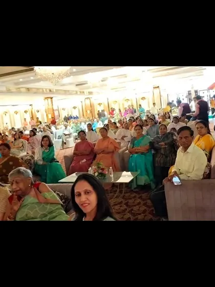 The family and friends at the 95th birthday event, watching the sand art performance with rapt attention.