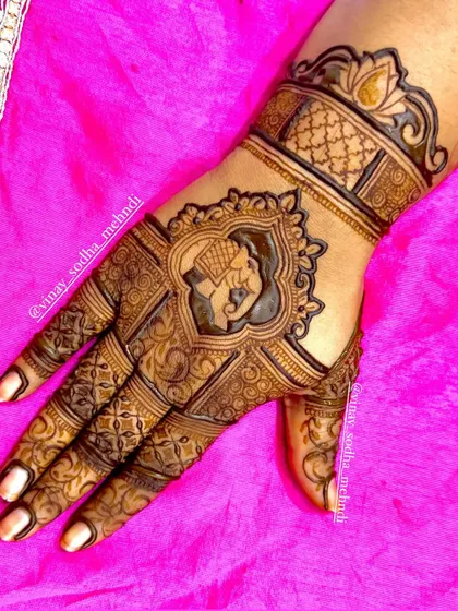 A detailed back-of-hand design featuring an elephant in an ornate frame. The intricate patterns around it showcase my fine-line work.