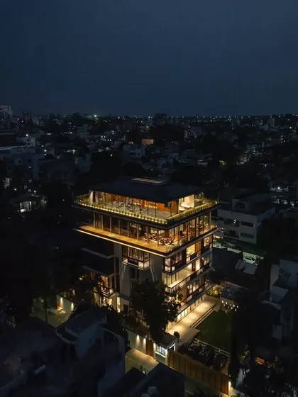 An aerial view of 'The Light House' at dusk, glowing warmly within its urban context and establishing its presence in the Nagpur neighborhood.
