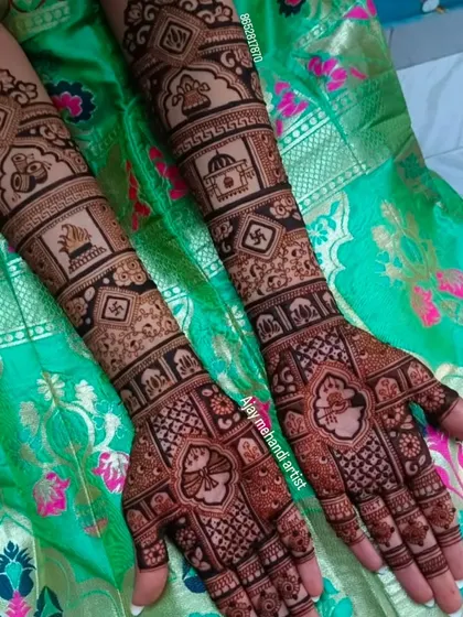 This design features traditional motifs arranged in neat blocks on the forearms, including elephants, kalash pots, and the auspicious swastika symbol.