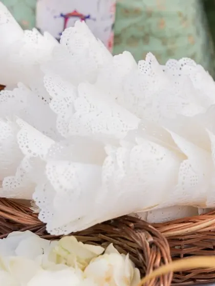 Paper cones filled with flower petals for guests to shower the couple with, a simple detail that involves everyone in the celebration.