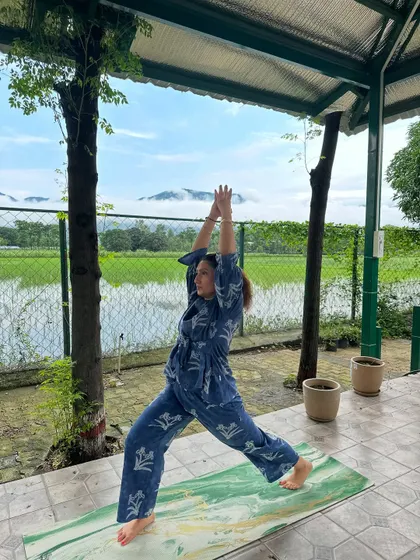 A powerful Warrior I pose, feeling grounded in the earth and reaching for the sky. Retreats are a perfect time to deepen your asana practice.