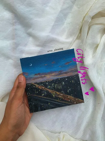 A small canvas painting of city lights at dusk. I can capture the mood of your favorite city view.