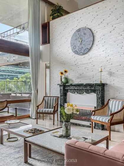 An elegant addition to this living room is the fireplace with a mantle made of Oasis Green Marble. It's thoughtfully designed to be both beautiful and safe for children, making the entire room feel cozier.
