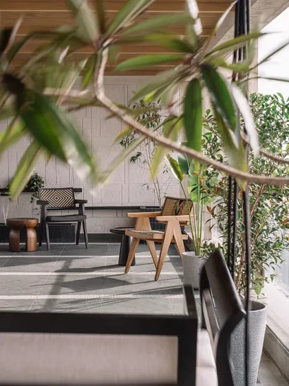The sea-facing deck is a sanctuary in the urban rush of Mumbai, blending tactile materials like Kota stone with natural greenery.