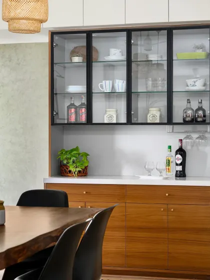 A custom-designed crockery and bar unit with a mix of open and closed storage, perfect for a modern dining space.
