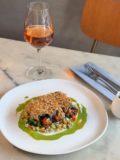 A vegetarian delight, our new Eggplant Rollatini. It's filled with a Mediterranean vegetable caponata and served over pearl couscous with a vibrant sauce verdure.