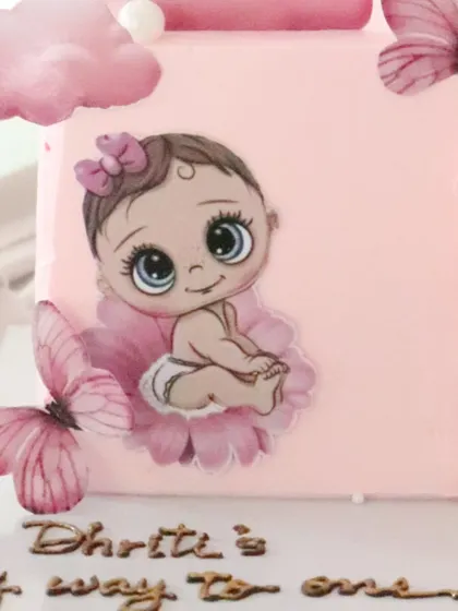 A close-up of the adorable baby illustration on this half-birthday cake. The details are all edible and so cute.