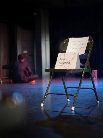 Another view of the stage set for a Playback Theatre Mela, with an actor in the background, ready for the unscripted performance to begin.