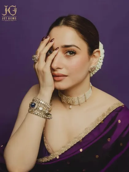 A captivating gaze, framed by the sparkle of our Polki choker, statement ring, and stacked bracelets. A truly regal look.