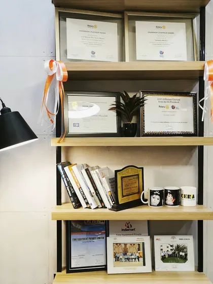 A close-up of a shelving unit in an office, displaying awards and books. This detail highlights how our designs provide a framework for our clients to personalize their space.