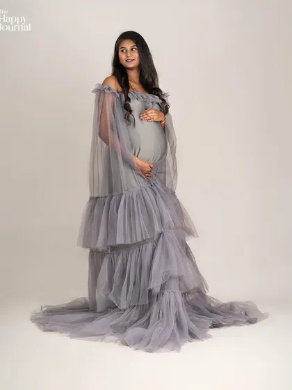 A slightly different angle of the stunning grey tulle gown, capturing a thoughtful and serene expression. Each photo tells a small part of the larger story.