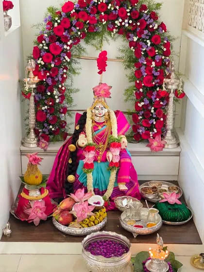 An outstanding Varamahalakshmi setup by our dear client Sahana, with the goddess looking divine in a pink and blue manSi Kanjeevaram.