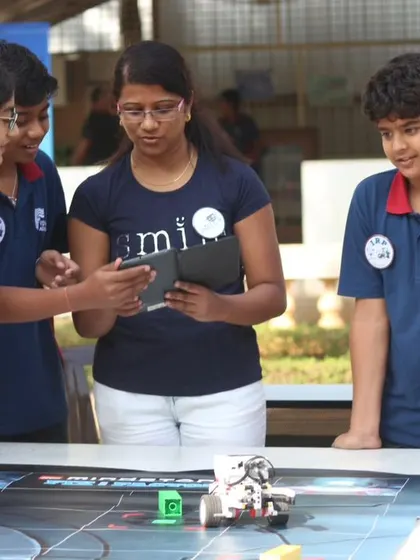 A group of students engaged in a robotics activity during an IRO orientation event. These hands-on sessions give prospective students a taste of what our program offers.