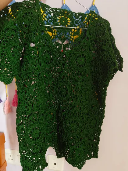 Another look at the green lace top, showing how the light passes through the openwork design. It’s a piece that feels both substantial and incredibly airy.