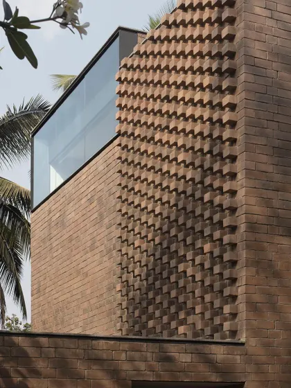 (Duplicate of 42) A close-up of the articulated brick facade, where bricks are rotated and projected to create a woven texture that changes with the movement of the sun.