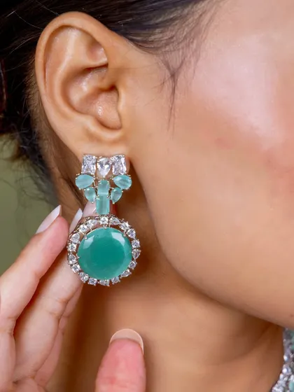 A close-up of the earring from our mint-green diamond-look set, highlighting the beautiful color and intricate design.